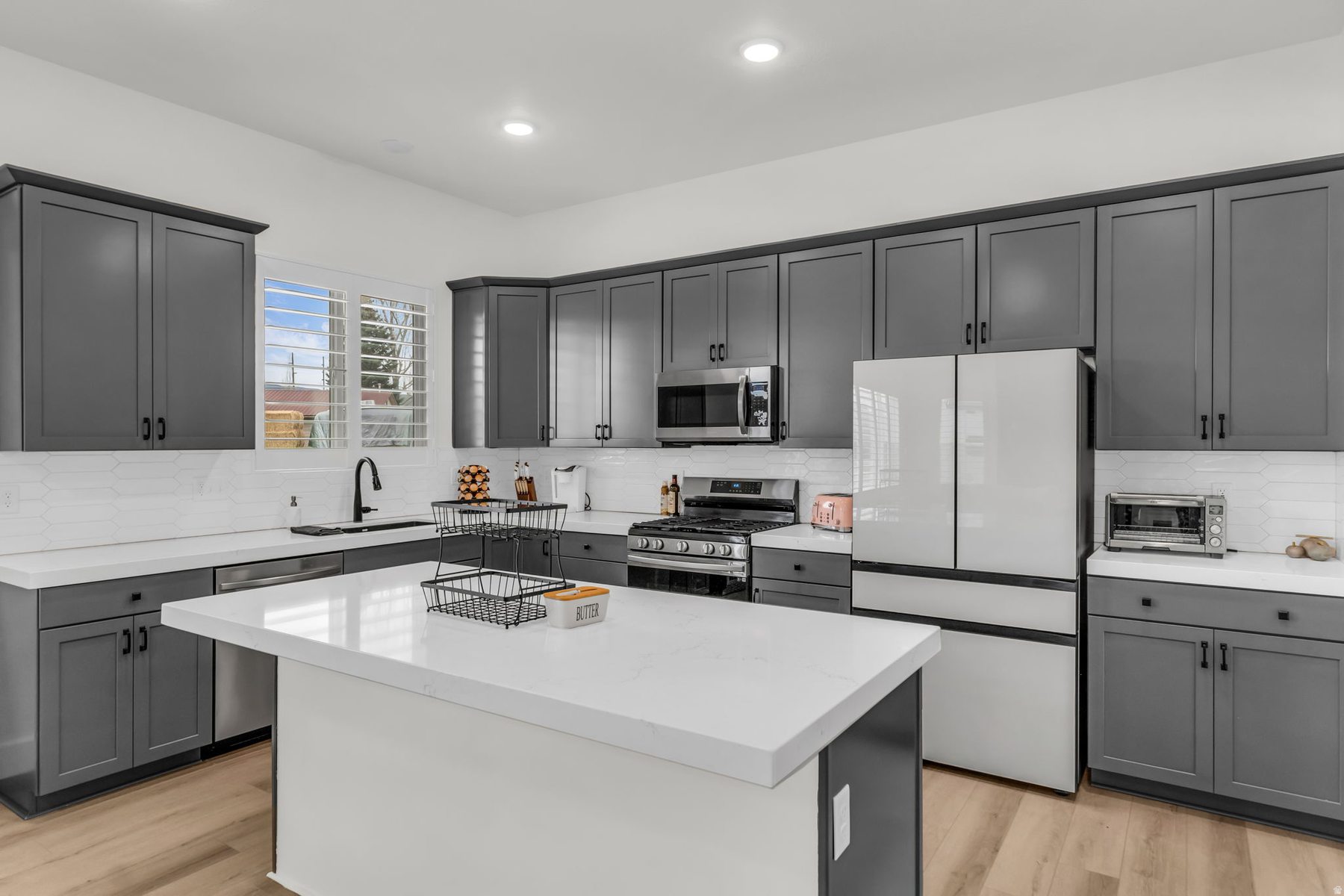 Kitchen at 1243 S 1040 E Heber City with gray shaker cabinets quartz island stainless appliances